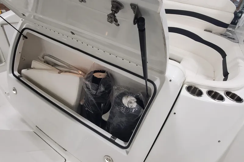 Slide: The Image of Open storage compartment on 2010 Formula 31 Performance Cruiser boat, showing interior items. - 7
