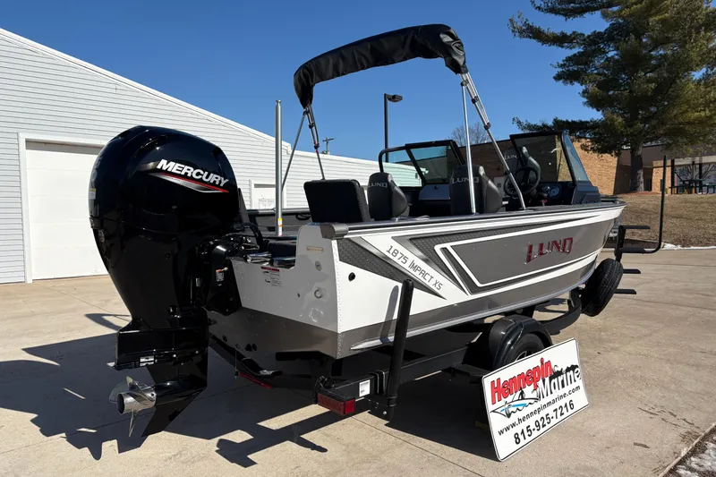Slide: The Image of 2026 Lund 1875 Impact XS Sport boat with Mercury engine on trailer. - 1