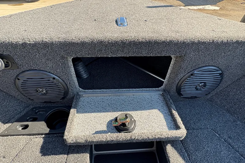 Slide: The Image of 2026 Lund 1875 Impact XS Sport boat interior with speakers and storage compartment. - 14