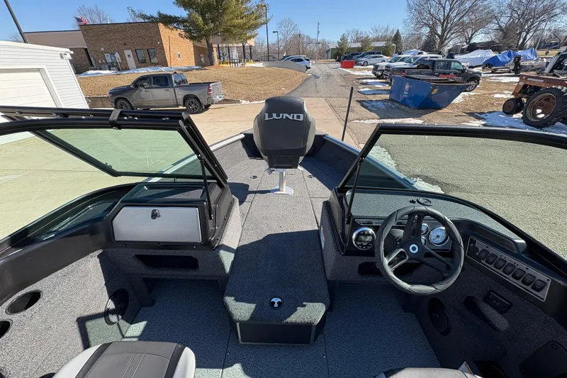 Slide: The Image of 2026 Lund 1875 Impact XS Sport boat interior with steering wheel and dashboard. - 15