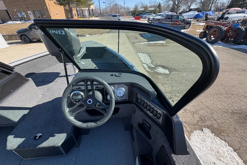 Slide: The Image of 2026 Lund 1875 Impact XS Sport boat dashboard with steering wheel and controls. - 19