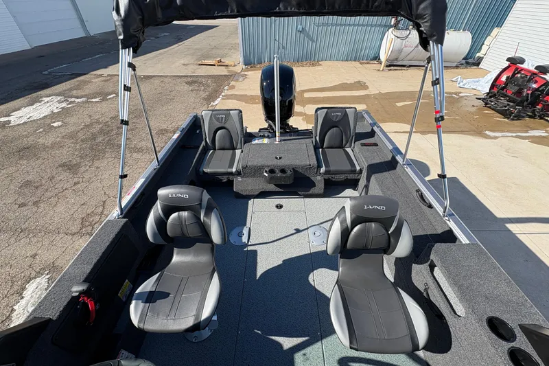 Slide: The Image of 2026 Lund 1875 Impact XS Sport boat interior with seating and canopy. - 22
