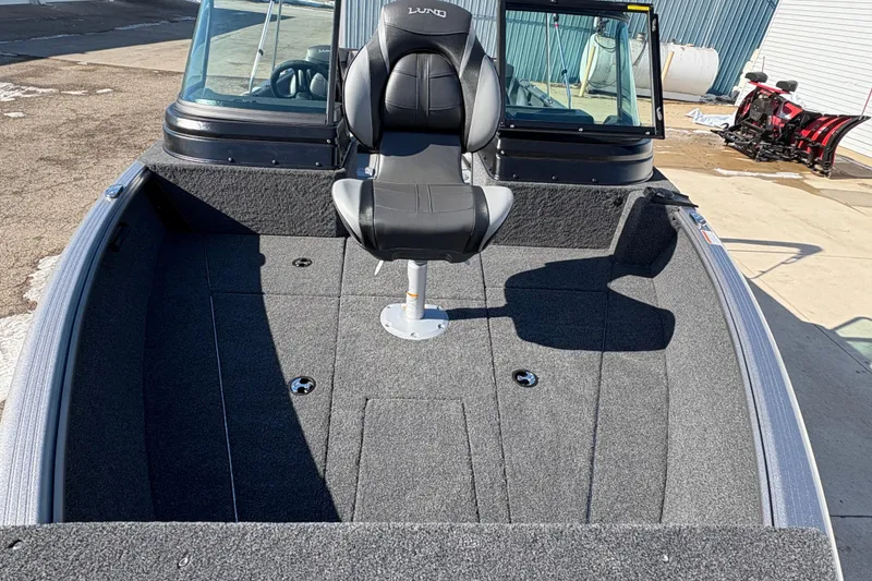 Slide: The Image of 2026 Lund 1875 Impact XS Sport boat interior with seating and windshield. - 7