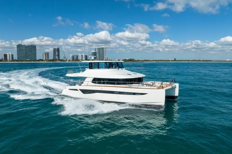 Slide: The Image of 2023 Granocean 57 yacht cruising near city skyline on a sunny day. - 10