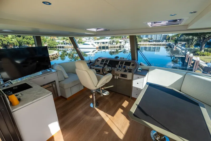 Slide: The Image of Luxurious 2023 Granocean 57 yacht interior with helm, seating, and waterfront view. - 16
