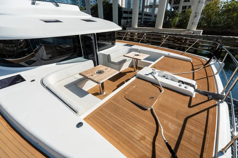 Slide: The Image of Luxurious 2023 Granocean 57 yacht deck with seating and tables, docked under a bridge. - 52