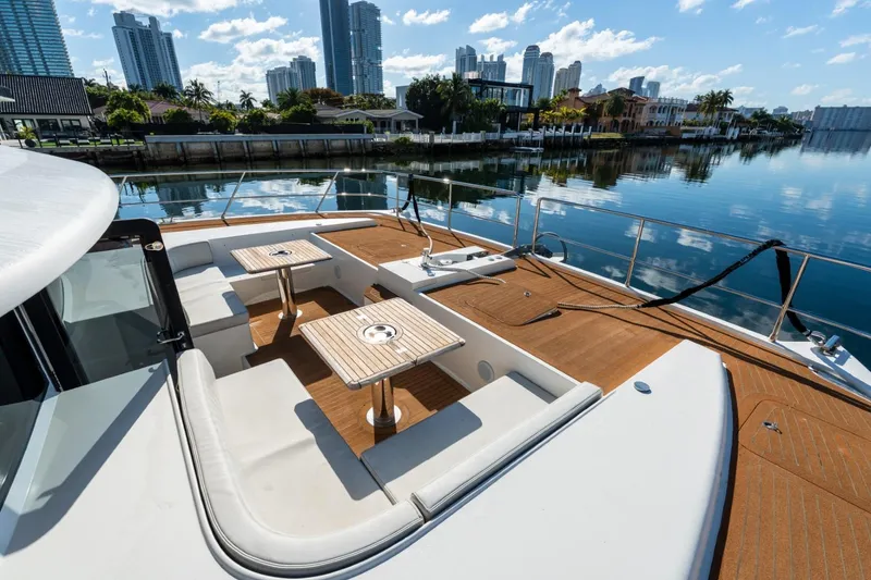 Slide: The Image of Luxurious 2023 Granocean 57 yacht with elegant deck seating and waterfront cityscape. - 55