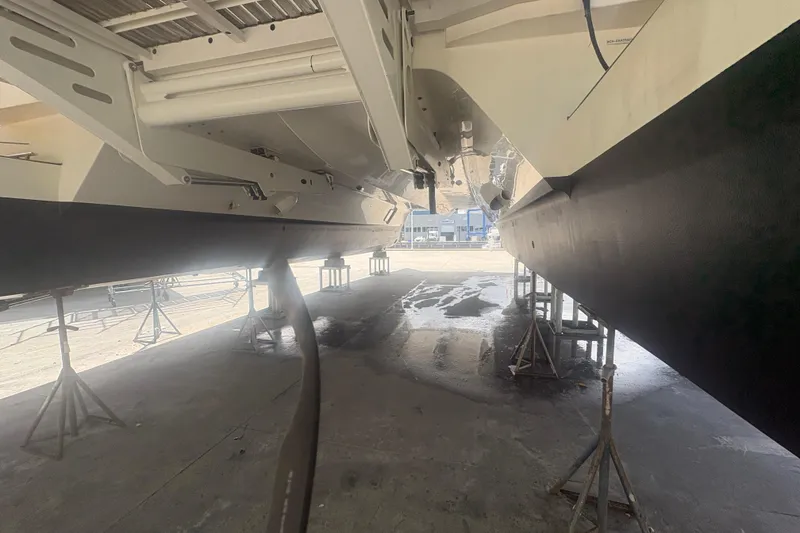 Slide: The Image of Underneath view of 2023 Granocean 57 catamaran on stands in a shipyard. - 74