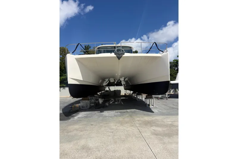 Slide: The Image of 2023 Granocean 57 catamaran on dry dock under clear blue sky. - 75
