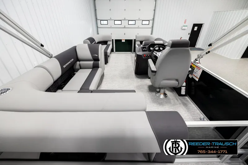Slide: The Image of 2026 Bennington SLJSF pontoon boat interior with gray seating and modern helm. - 16
