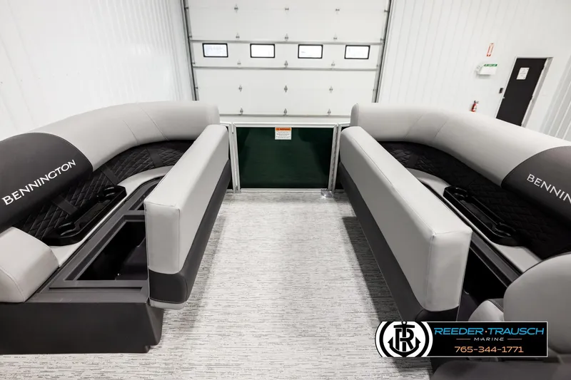 Slide: The Image of 2026 Bennington SLJSF boat interior with gray seating and cup holders in showroom. - 19