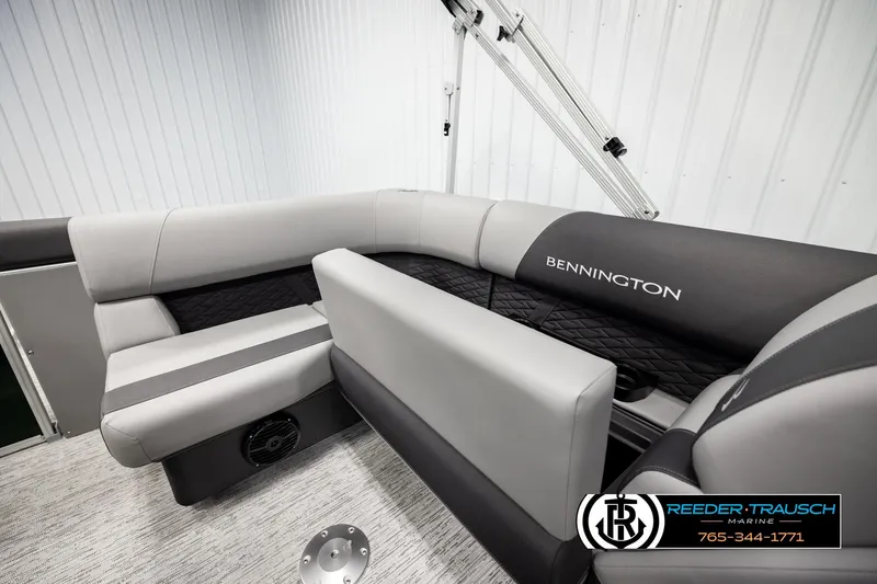 Slide: The Image of 2026 Bennington SLJSF boat interior with gray seating and logo, Reeder Trausch Marine branding. - 23