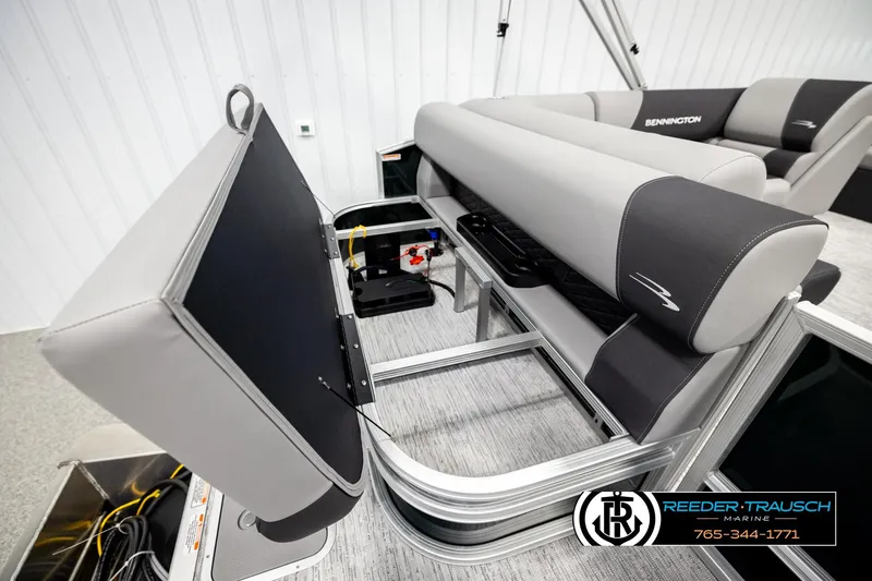 Slide: The Image of 2026 Bennington SLJSF boat interior with open storage compartment and sleek seating design. - 27