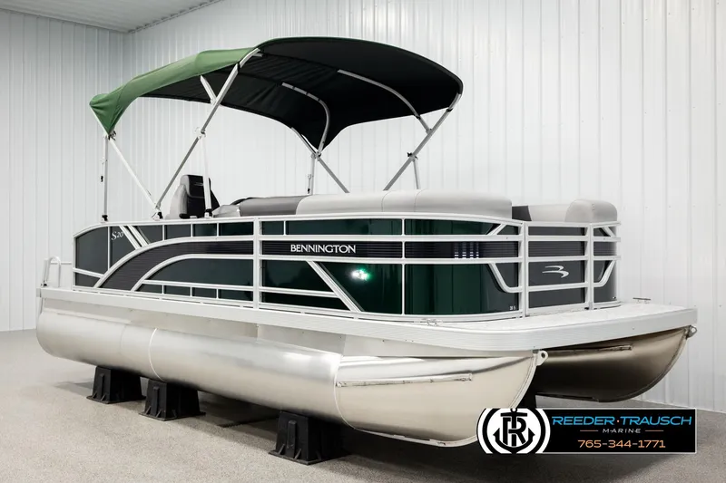Slide: The Image of 2026 Bennington SLJSF pontoon boat with green canopy in showroom. - 3