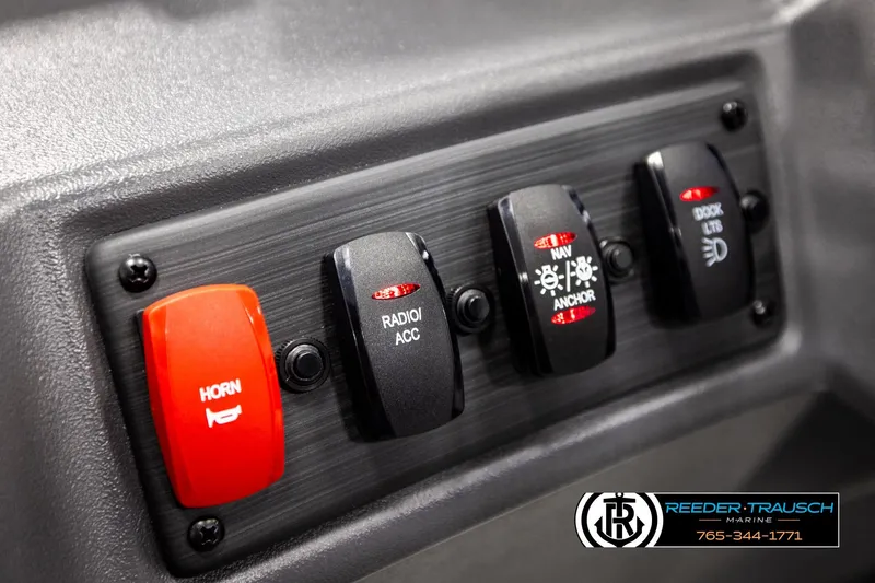 Slide: The Image of Control panel of 2026 Bennington SLJSF boat with labeled switches for horn, radio, and lights. - 31