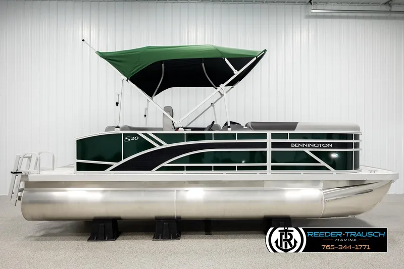 Slide: The Image of 2026 Bennington SLJSF pontoon boat with green canopy in showroom. - 5
