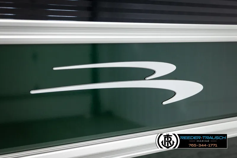 Slide: The Image of 2026 Bennington SLJSF boat logo on green surface, Reeder-Trausch Marine branding. - 51