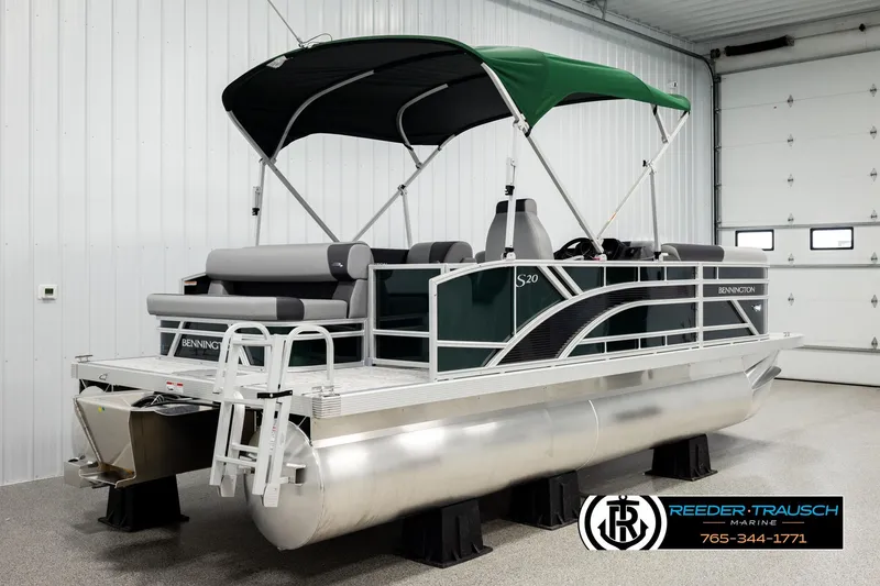 Slide: The Image of 2026 Bennington SLJSF pontoon boat with green canopy in showroom. - 6