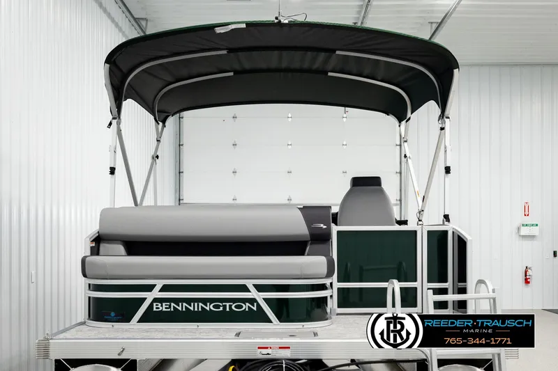 Slide: The Image of 2026 Bennington SLJSF pontoon boat in showroom with canopy and seating. - 7