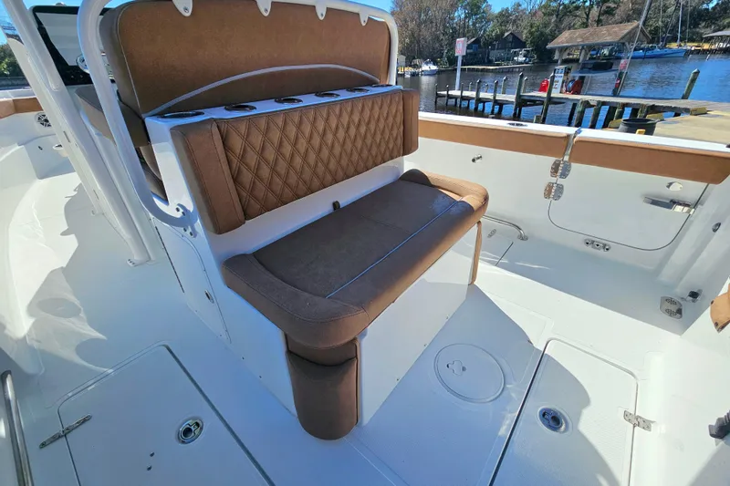 Slide: The Image of 2026 Sea Hunt Ultra 275 Coffin Box boat interior with cushioned seating and storage. - 12