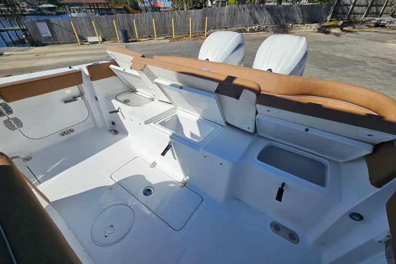Slide: The Image of 2026 Sea Hunt Ultra 275 Coffin Box boat interior with open storage compartments. - 13