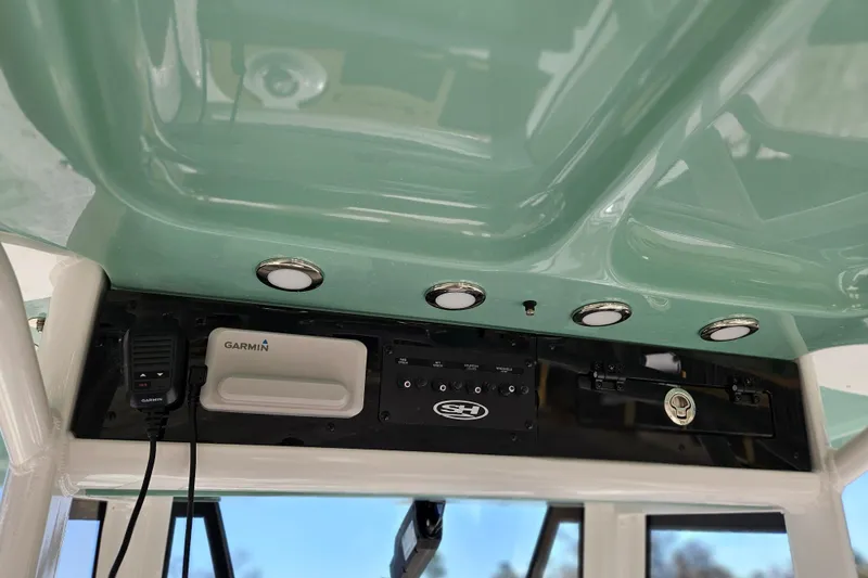 Slide: The Image of 2026 Sea Hunt Ultra 275 Coffin Box boat console with Garmin electronics and overhead lighting. - 16