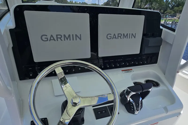 Slide: The Image of 2026 Sea Hunt Ultra 275 Coffin Box helm with dual Garmin displays and steering wheel. - 18