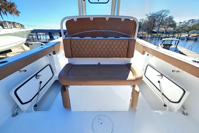 Slide: The Image of 2026 Sea Hunt Ultra 275 Coffin Box boat interior with cushioned seating and storage compartments. - 20