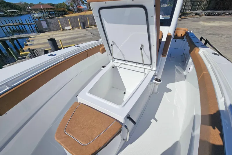 Slide: The Image of 2026 Sea Hunt Ultra 275 Coffin Box open on deck, showcasing spacious storage. - 26
