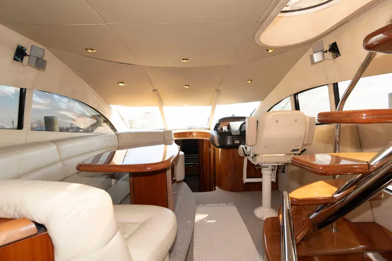 Slide: The Image of Luxurious interior of a 2003 Sunseeker Manhattan 56 yacht with elegant seating and wooden accents. - 13