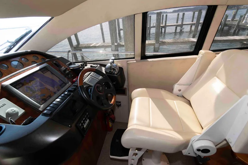 Slide: The Image of Helm of 2003 Sunseeker Manhattan 56 yacht with navigation equipment and leather captain's chair. - 16