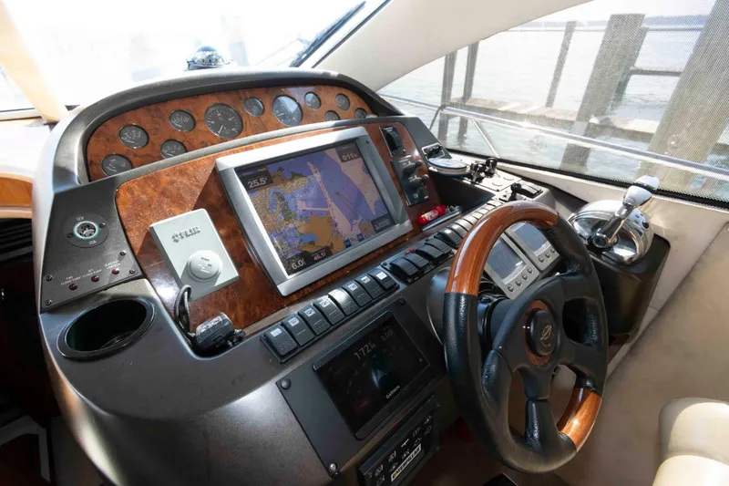 Slide: The Image of Cockpit of 2003 Sunseeker Manhattan 56 yacht with navigation controls and steering wheel. - 17