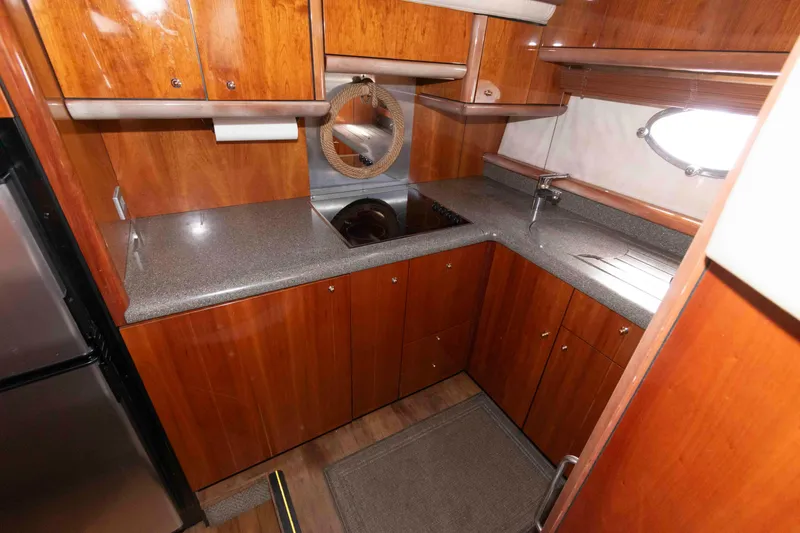 Slide: The Image of Luxurious kitchen interior of 2003 Sunseeker Manhattan 56 yacht with wooden cabinetry. - 19