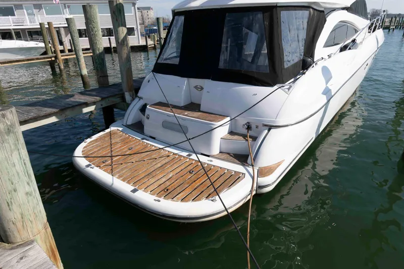 Slide: The Image of 2003 Sunseeker Manhattan 56 yacht docked at marina, rear view. - 2