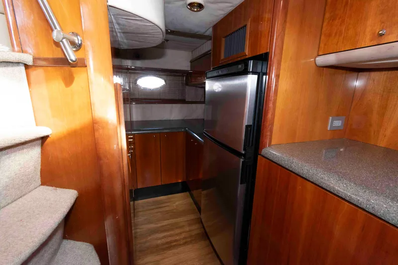 Slide: The Image of Interior of 2003 Sunseeker Manhattan 56 yacht with wooden cabinetry and stainless steel appliances. - 20