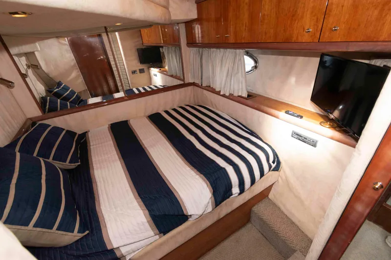 Slide: The Image of Luxurious cabin interior of 2003 Sunseeker Manhattan 56 yacht with striped bedding. - 24