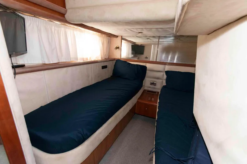 Slide: The Image of 2003 Sunseeker Manhattan 56 yacht cabin with twin beds and TV. - 25