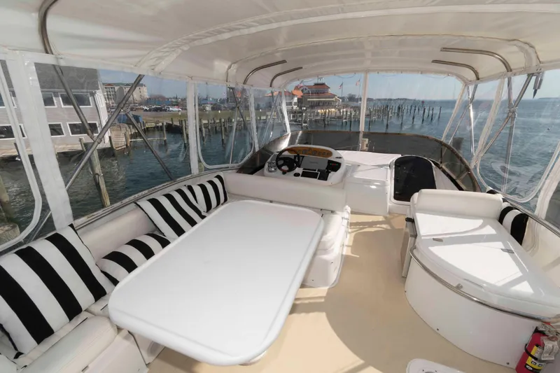 Slide: The Image of Luxurious 2003 Sunseeker Manhattan 56 yacht interior with striped seating and waterfront view. - 6