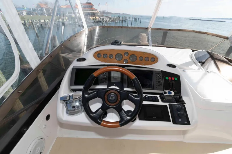 Slide: The Image of Cockpit of 2003 Sunseeker Manhattan 56 yacht with steering wheel and navigation controls. - 9