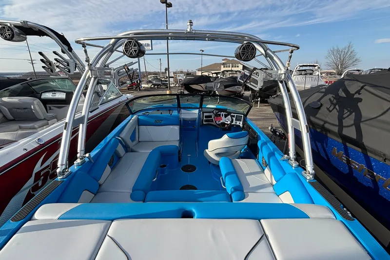 Slide: The Image of 2017 MasterCraft NXT20 boat with blue interior and wakeboard tower in a marina. - 11