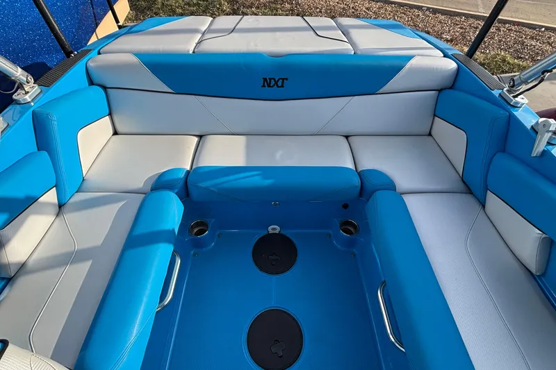 Slide: The Image of 2017 MasterCraft NXT20 boat interior with blue and white seating. - 12