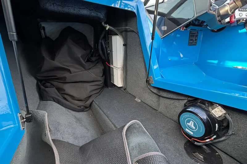 Slide: The Image of 2017 MasterCraft NXT20 interior showing storage area and audio equipment. - 20