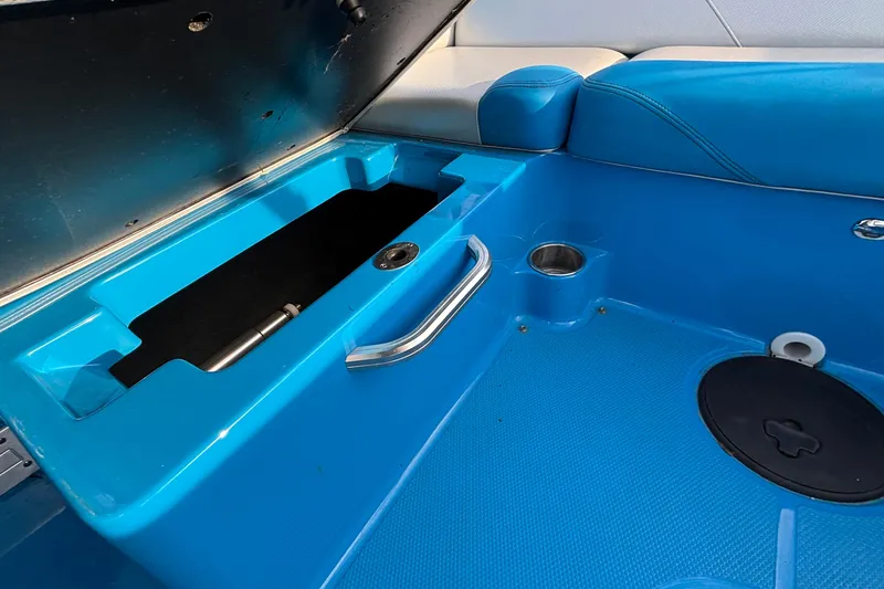 Slide: The Image of 2017 MasterCraft NXT20 boat interior with blue storage compartment and seating. - 21