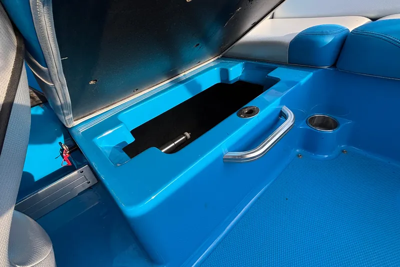 Slide: The Image of 2017 MasterCraft NXT20 boat interior storage compartment with blue upholstery and metal handle. - 22