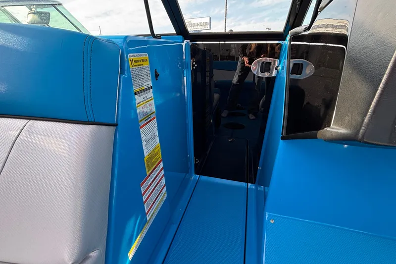 Slide: The Image of 2017 MasterCraft NXT20 interior with blue seating and safety labels. - 24