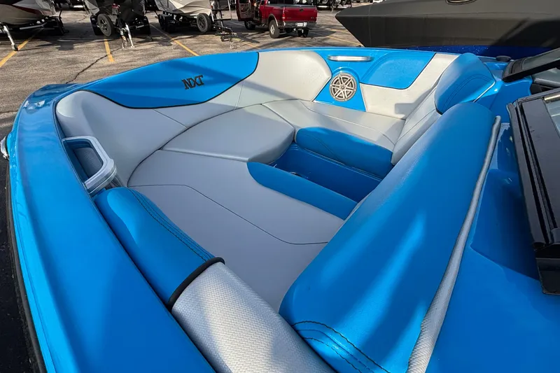 Slide: The Image of 2017 MasterCraft NXT20 boat interior with blue and gray seating, featuring a speaker. - 5