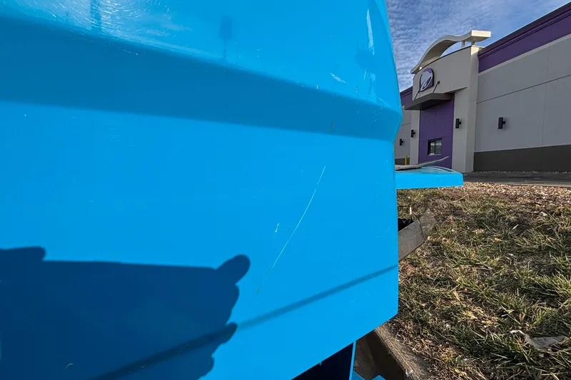 Slide: The Image of Blue MasterCraft NXT20 boat near a building, showcasing vibrant color and sleek design. - 7