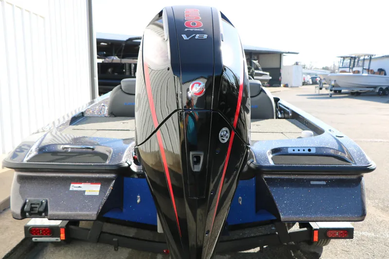 Slide: The Image of 2027 Caymas 201 Pro boat with powerful V8 engine, parked outdoors. - 10