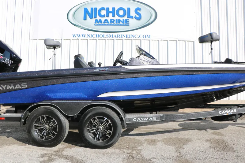 Slide: The Image of 2027 Caymas 201 Pro boat in blue on trailer at Nichols Marine dealership. - 12