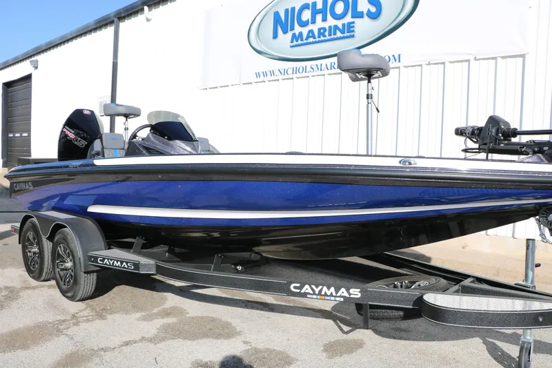 Slide: The Image of 2027 Caymas 201 Pro boat in blue on trailer at Nichols Marine dealership. - 13